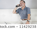 Adult Male Talking on a Mobile Phone. 11429238