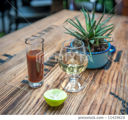 Shot of tequila, sangrita and lime - drink mexican style 11429628