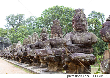 Angkor Thom (ancient royal city) entrance bridge with row of dem 11430483