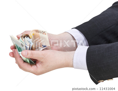 pile of euro banknotes in businessman handful 11431004