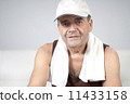 Adult male relaxes after exercising in the fitness gym. 11433158