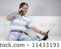 Adult Male Relaxing having a coffee and reading a magazine. 11433191
