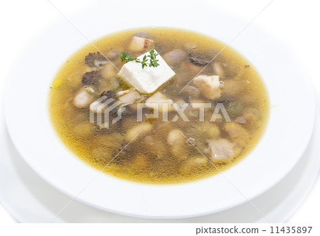 soup with beans and mushrooms garnished with goat cheese 11435897