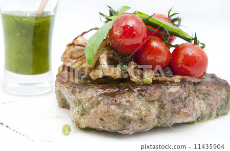 steak with tomato sauce and mushrooms on a white background in the restaurant 11435904
