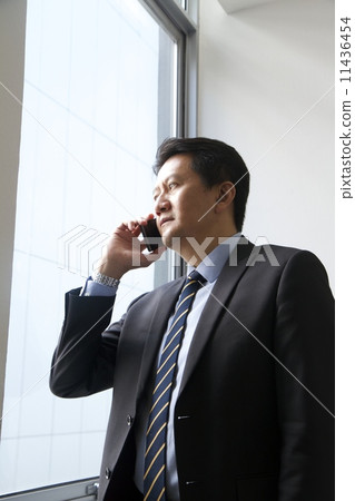 Asian businessman with mobile phone Asian businessman with mobile phone 11436454