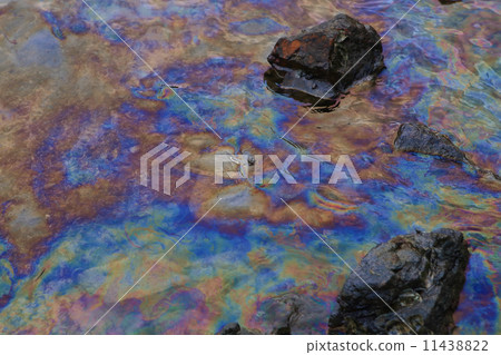 crude oil in sea water and rainbow reflection crude oil in sea water and rainbow reflection 11438822