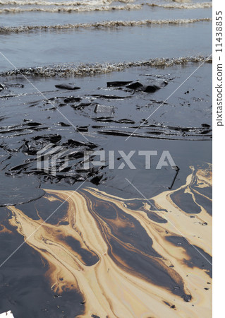 crude oil spill on the stone at the beach crude oil spill on the stone at the beach 11438855