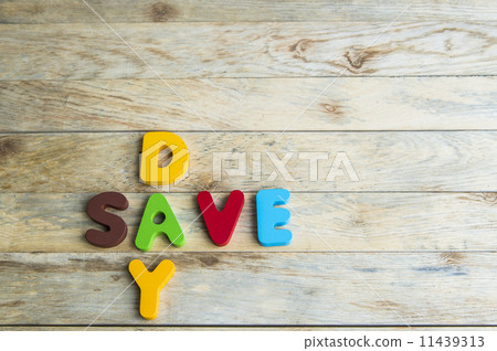 Colorful wooden word Day and Save on wooden floor 11439313