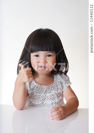 The girl in front of the table The girl in front of the table 11440112