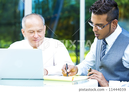 Young executive making presentation to senior executive on laptop Young executive making presentation to senior executive on laptop 11444039