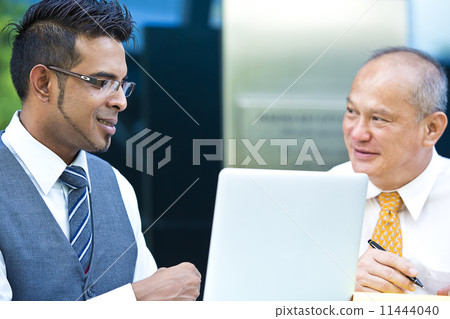 Young executive making presentation to senior executive on laptop Young executive making presentation to senior executive on laptop 11444040