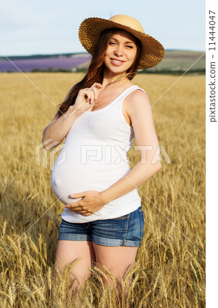 Happy pregnant woman portrait in a wheat field. Happy pregnant woman portrait in a wheat field. 11444047