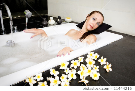 Girl lays in soapsuds in bathing, full water.. Girl lays in soapsuds in bathing, full water.. 11444216