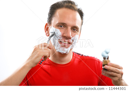 The sports man has a shave- with the razor and a small brush.. The sports man has a shave- with the razor and a small brush.. 11444301