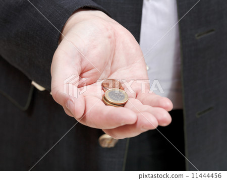 pile of coins in businessman's hand pile of coins in businessman's hand 11444456