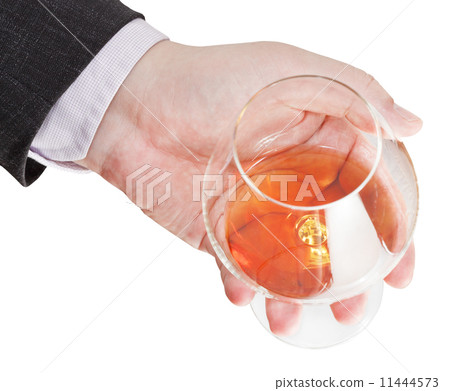 above view of cognac glass in businessman hand above view of cognac glass in businessman hand 11444573