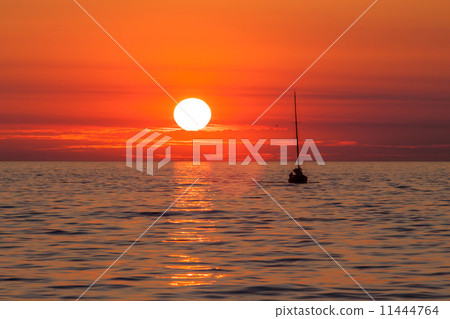 Yacht sailing against sunset. 11444764