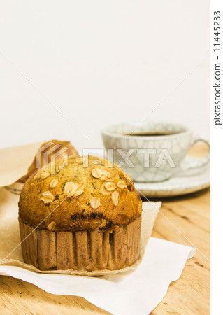 Almond muffins with coffee cup on wood table Almond muffins with coffee cup on wood table 11445233