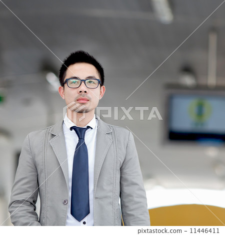 Happy smart asian business man in business center of ASEAN Economic Community - AEC 11446411