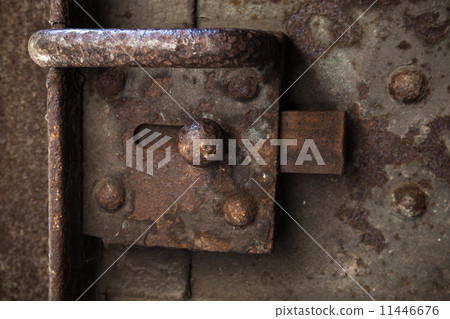 Old rusted lock on dark steel door 11446676
