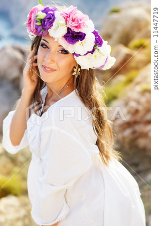Beautiful young woman with wreath of flowers  11447719