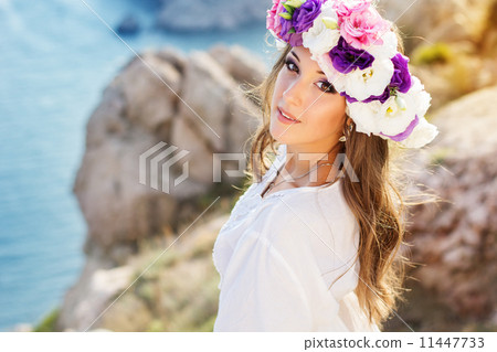 Beautiful young woman with wreath of flowers Beautiful young woman with wreath of flowers 11447733