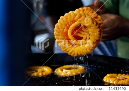 Cropped image of vendor preparing jalebis at stall 11453690