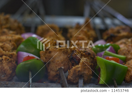 Close-up of chicken and vegetables being barbecued 11453746