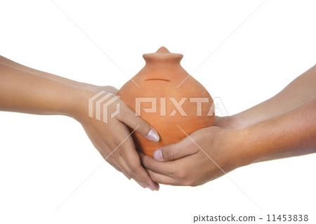 Cropped image of couple holding piggy bank over white background 11453838