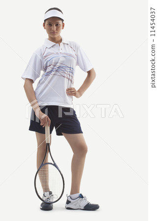 Portrait of young woman with hand on hip holding tennis racket isolated over white background 11454037