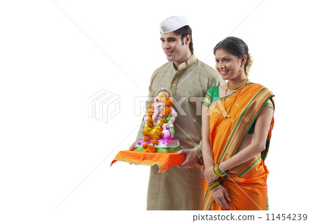 Maharashtrian couple with a Ganesh idol Maharashtrian couple with a Ganesh idol 11454239