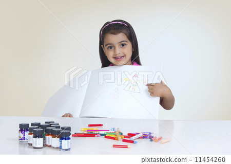 Portrait of girl showing drawing against white background Portrait of girl showing drawing against white background 11454260