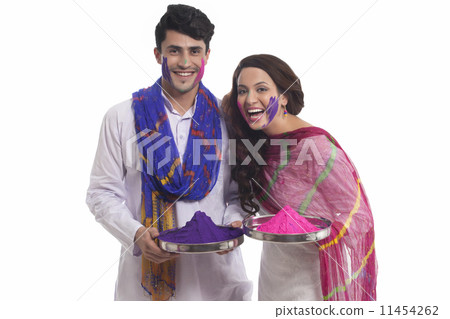 Portrait of a couple with holi colours enjoying 11454262