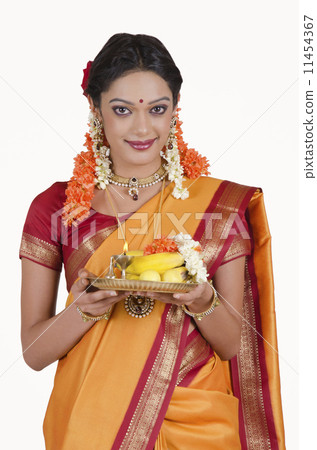 Portrait of a South Indian woman holding a thali Portrait of a South Indian woman holding a thali 11454367