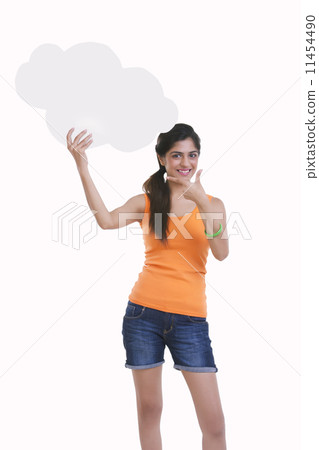 Portrait of beautiful young woman pointing at thought bubble over white background Portrait of beautiful young woman pointing at thought bubble over white background 11454490