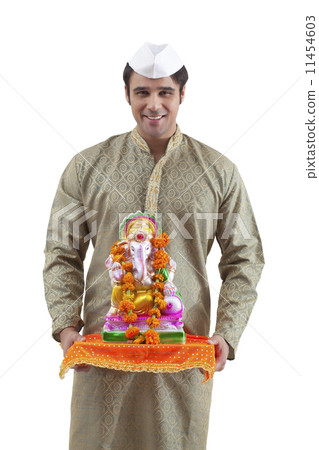 Portrait of a Maharashtrian man holding a Ganesh idol 11454603