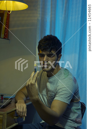 Young drug addict holding syringe at home Young drug addict holding syringe at home 11454665