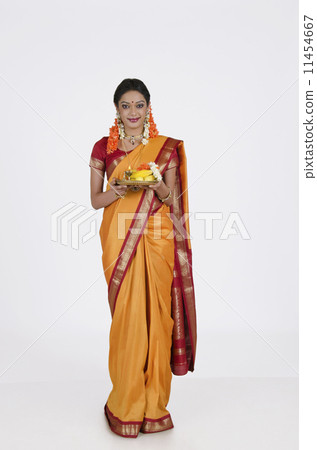 Portrait of a South Indian woman holding a thali Portrait of a South Indian woman holding a thali 11454667