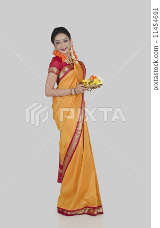 Portrait of a South Indian woman holding a thali Portrait of a South Indian woman holding a thali 11454691