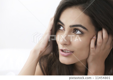 Close-up of thoughtful young woman looking at copy space 11454801