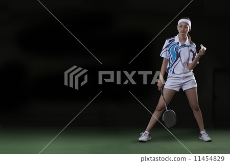 Full length of young woman with badminton racket and shuttlecock Full length of young woman with badminton racket and shuttlecock 11454829
