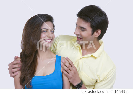 Romantic young couple looking at each other on white background Romantic young couple looking at each other on white background 11454963
