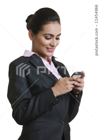 Happy young businesswoman using mobile phone isolated over white background Happy young businesswoman using mobile phone isolated over white background 11454966