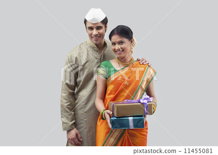 Portrait of Maharashtrian couple holding gifts Portrait of Maharashtrian couple holding gifts 11455081