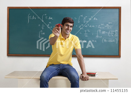 Portrait of a college student with a paper aeroplane 11455135