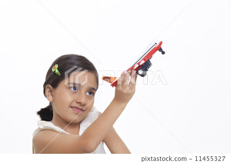 Girl playing with toy aeroplane Girl playing with toy aeroplane 11455327