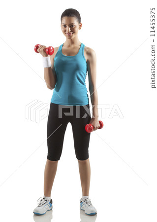 Portrait of woman lifting dumbbells isolated over white background Portrait of woman lifting dumbbells isolated over white background 11455375
