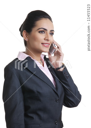 Businesswoman in suit using mobile phone over white background 11455523