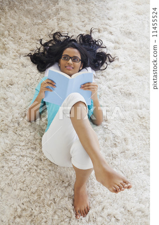 Woman with a book thinking 11455524