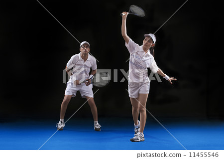 Players playing tennis doubles at court 11455546